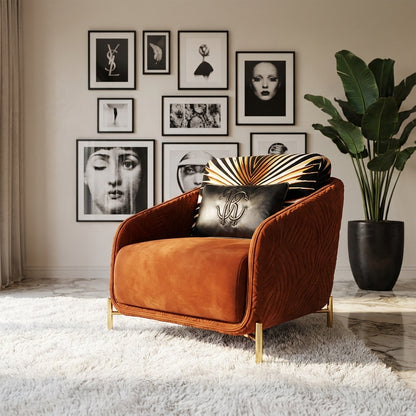 Modern living room featuring a burnt orange velvet armchair, gold legs, luxury decor, and a gallery wall of black-and-white art.